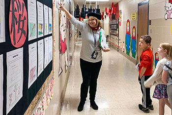 A teacher dresses up in character for a class of students at Chimney Lakes Elementary School